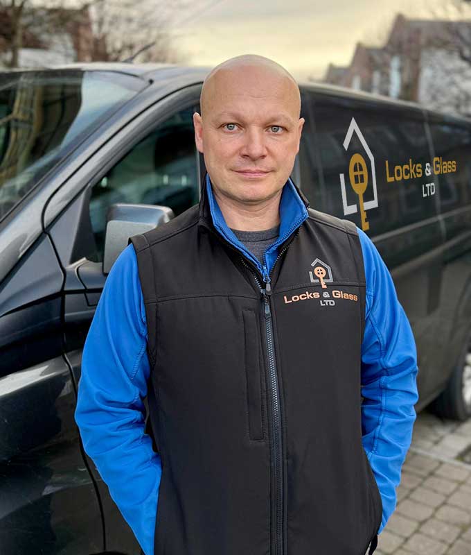 Olexander, professional Dartford locksmith and owner of Locks & Glass, standing beside the company van.